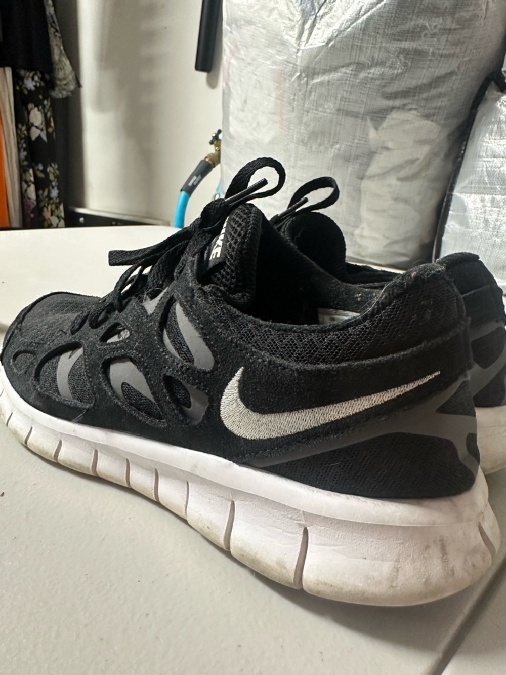Nike Free Run 2 sneakers in black, white, and dark grey  MSRP$110